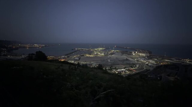 Port town and sea at night aerial