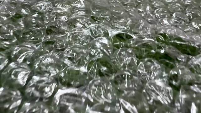 Closeup view of transparent bubble wrap showcasing intricate textures and light reflections