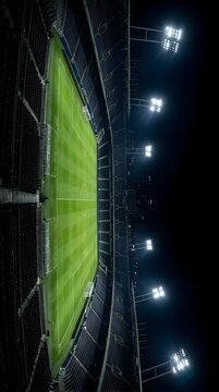 Vertical aerial view of a lit sports stadium at night.