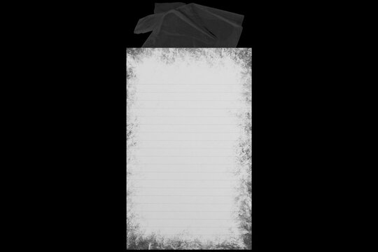 a piece of notebook paper stuck together with a torn piece of tape