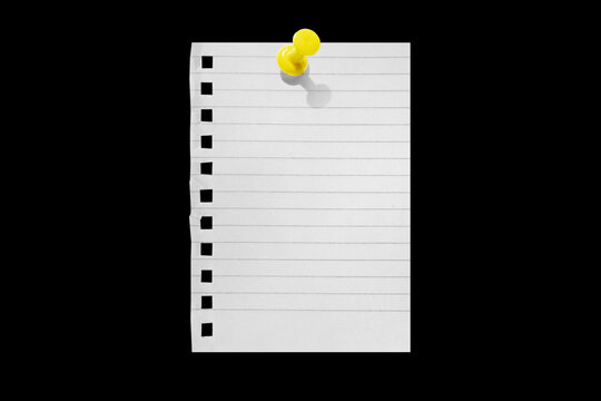 Torn notebook paper attached with a push pin isolated on a black background.
