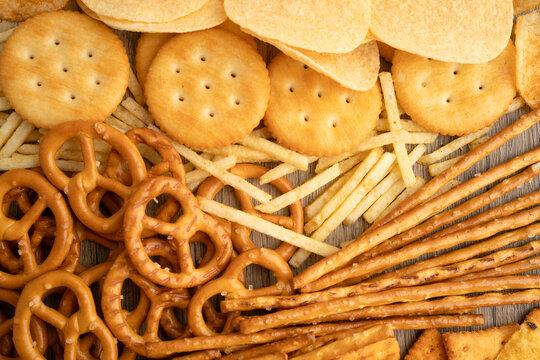 Mix of variety snack chips pretzel and cracker, junk crunchy food.