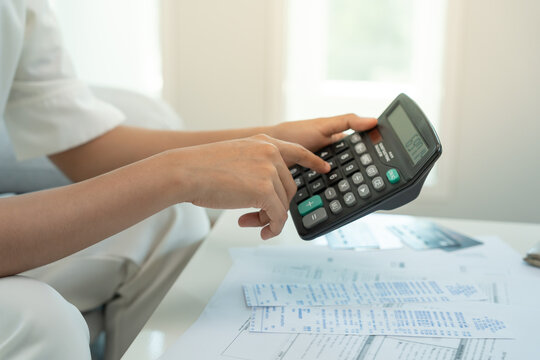 headache woman with large bills or invoices, No money on pocket to pay to expenses and credit card debt. shortage, Financial problem, bankruptcy, mortgage, loan, bankrupt, poor, empty wallet
