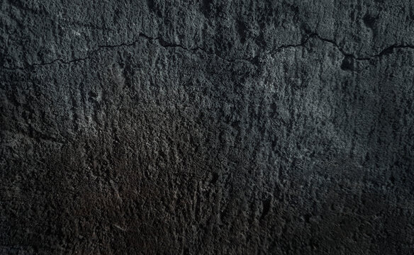 Grunge cracked concrete background fo the dark wall.