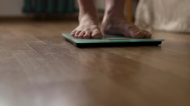Low Angle View of Person Standing Balanced on Digital Scale