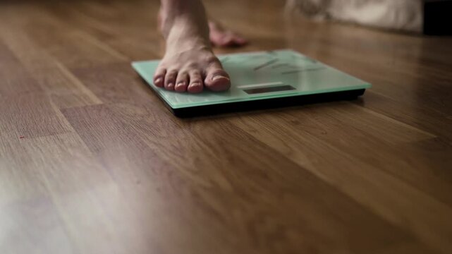 Single Foot Stepping Onto Smart Glass Scale on Wood Floor