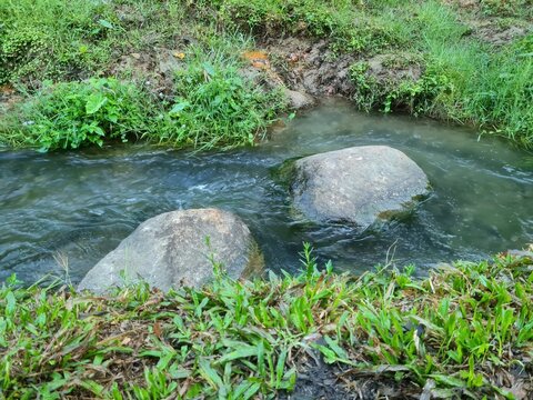 Clear water flowing in small river at the foot of Mount Kelud,located in Blitar,East Java,Indonesia