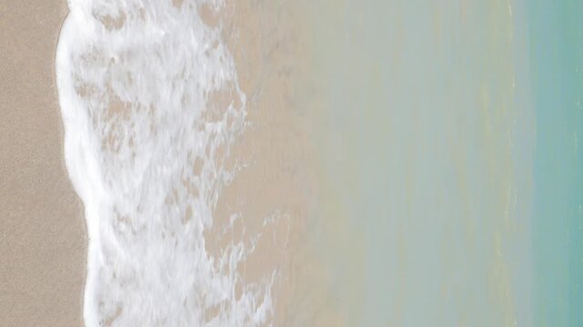 vertical natural landscape sea beach sea water surface while sea waves is crashing on golden white sand beach splashing white bubble.seascape summer holiday background,summer beach south of thailand