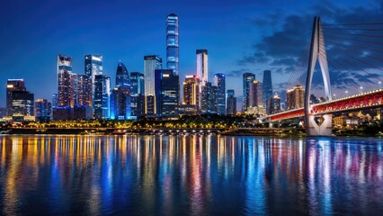 Obraz premium Illuminated modern city skyline at blue hour with skyscrapers, a cable-stayed bridge and vivid reflections on a calm river