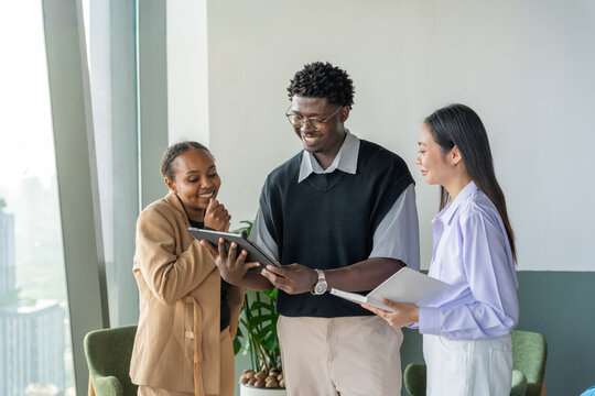 Team Members Discuss Ideas in a Modern Office Setting in the Afternoon