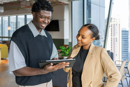 Colleagues Discuss Work During a Meeting in a Bright Office