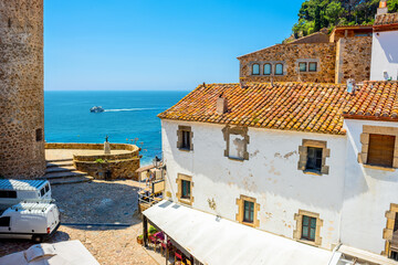 Obraz premium View of historical houses at old district near beach in Tossa de Mar. Costa Brava, Catalonia, Spain