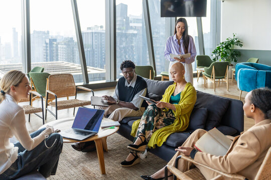 Team Meeting in a Modern Office Space With Large Windows