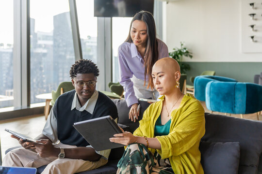 People Discuss Ideas While Working in a Modern Office Space