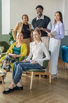 Group Portrait of People Standing and Sitting in a Modern Office Space