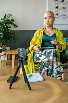 Woman Gives a Presentation While Sitting at a Table in a Room