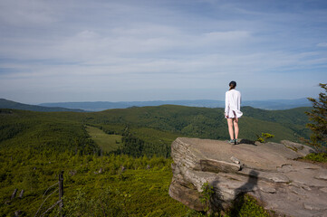Obraz premium Young Woman Standing on Rock Edge Enjoying Mountain Panorama View, Hiking Lifestyle