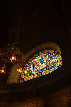 Epic ancient gothic church cathedral interior stone arch vault stained glass vertical.
