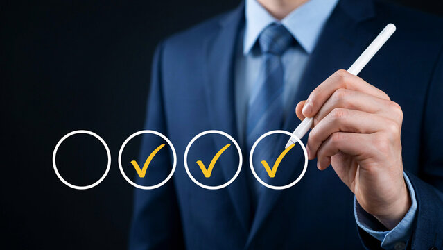 Businessman in a blue suit filling out digital checklist survey evaluation and task management