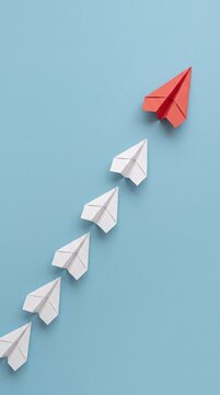 paper boat leadership concept - red paper boat leading the row