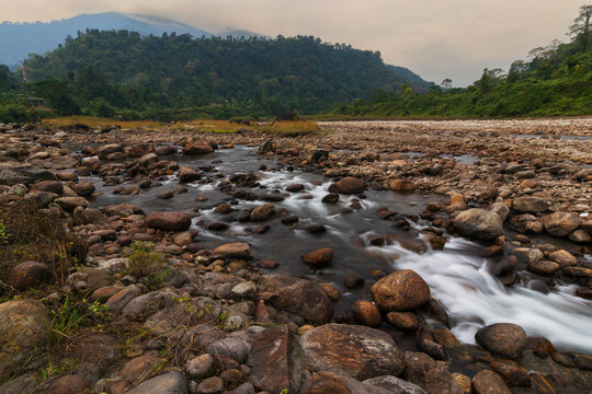 Scenic beauty of Jaldhaka River and stones at river bed, flowing through India, Bhutan, and Bangladesh. Originating from Kupup Lake in East Sikkim. At Jhalong-Dooars, north bengal- West Bengal, India.