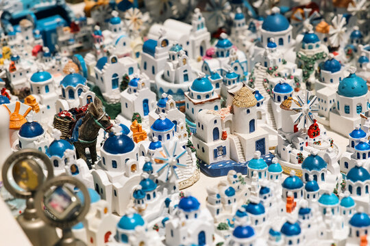 Detailed miniature models of Santorini&rsquo;s iconic whitewashed houses, blue domes, and windmills, capturing the charm and craftsmanship of Greek island souvenirs.