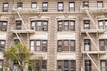 Fototapeta premium Historic New York City Apartment Building Facade with Fire Escapes