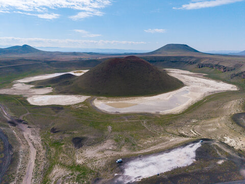 Explore the stunning Meke Crater Lake in Konya, Turkey, where unique geological formations meet vibrant colors. The serene landscape invites adventurers and nature lovers alike.