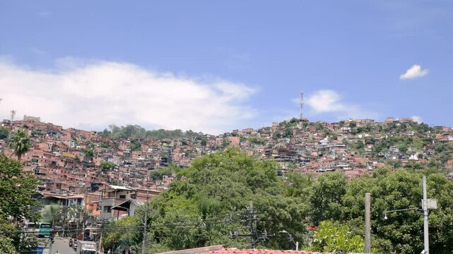 Medell&iacute;n, Colombia - 2026-07-21 - Panoramic View of Comuna 13 Hillside Residential Neighborhood and Urban Landscape, Video Recorded in 4K at 60fps