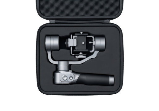 A handheld gimbal stabilizer for smartphones stored inside a protective foamlined carrying case isolated on transparent background