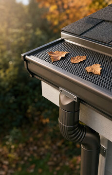 Modern Gutter Guard System with Autumn Leaves on Roof