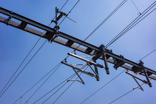 Overhead electrical wires and metal structures forming a railway catenary system