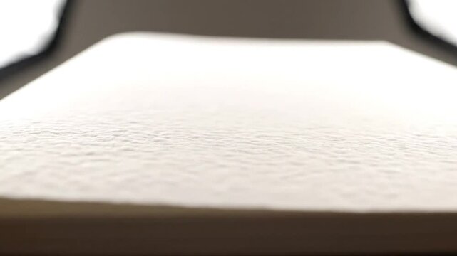 Close-up perspective of a white textured paper surface with natural imperfections suitable for artistic or crafting endeavors
