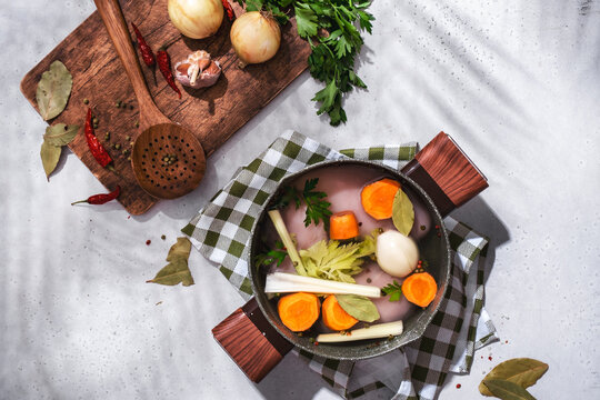 Raw chicken fillet broth ingredients. Home cooking background with fresh vegetables, herbs, and spices.