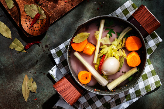 Traditional homemade chicken soup preparation with fresh ingredients