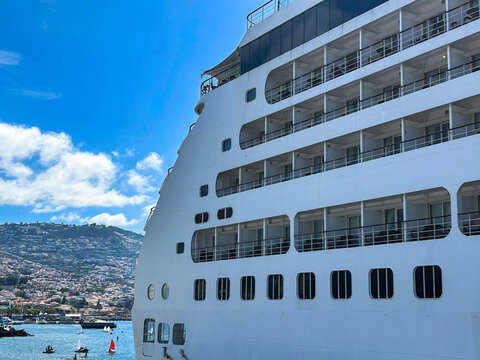 View of the white cruise liner and city on a summer day. Close-up. Funchal. Madeira. Portugal.