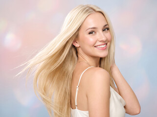 Naklejka premium Blonde woman with long healthy hair. Smiling female model with glowing skin.