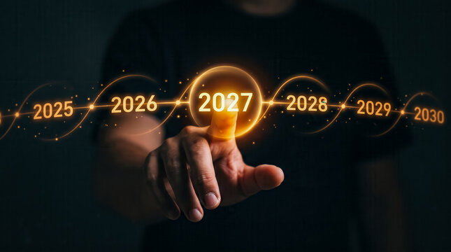 Professional hand selecting illuminated year 2027 from futuristic digital timeline display