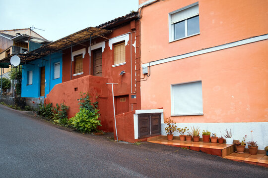Colorful traditional rural houses on a steep street along the Camino Primitivo trail in Asturias, Spain