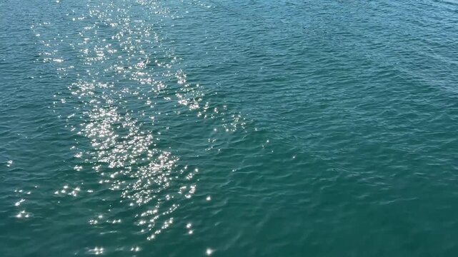 Ocean blue glittering waves surface.