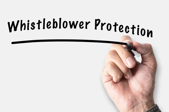Hand writing Whistleblower Protection text with marker on white background, corporate ethics and legal rights concept