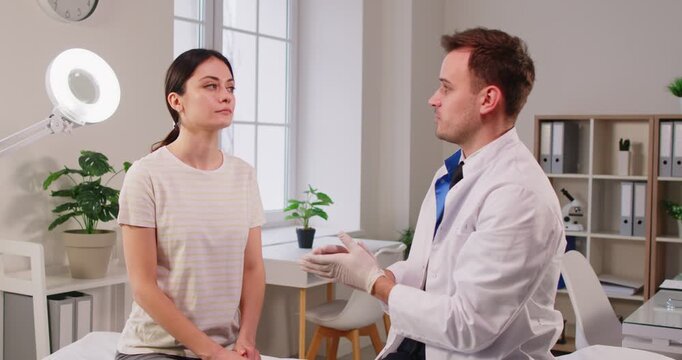 Cosmetic surgery planning, plastic surgeon consulting female patient in clinic, attractive young woman with doctor touches face, discussing professional cosmetology care, skincare, beauty, appearance