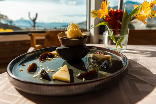 Gourmet presentation of traditional Ecuadorian figs with cheese dessert served on a ceramic plate