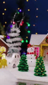 A yellow car drives into the center of the Christmas town