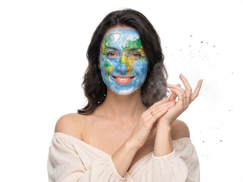 Girl adorned with bold colorful face paint