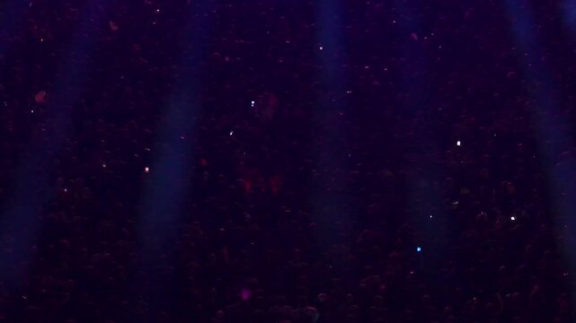 High angle aerial view of massive crowd dancing at live music festival concert