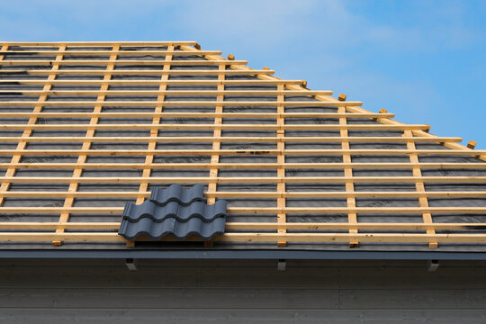 Roof battens and underlayment prepared for roof tile installation on modern timber frame house