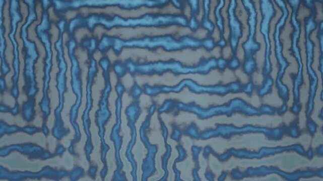 Seamless looping background of blue wavy lines on gray surface