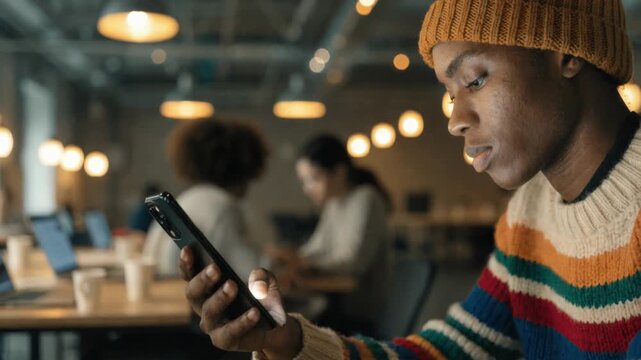 Closeup medium shot of team member confirming service golive on a digital checklist while office activity remains blurred.