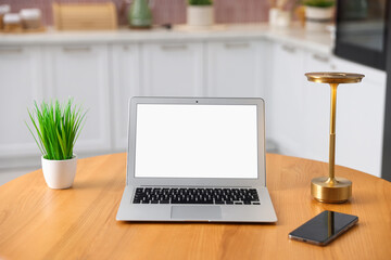 Fototapeta premium Comfortable workplace with laptop on wooden table indoors